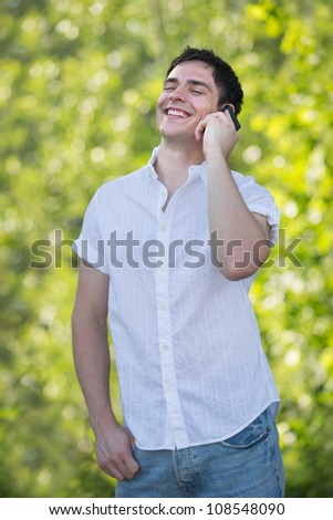 Casual Dressed Young Man Laugh Out Loud  on Cell Phone Outdoor