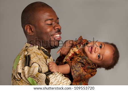 Happy African American Father Holding Baby Playing Isolated on Grey Background