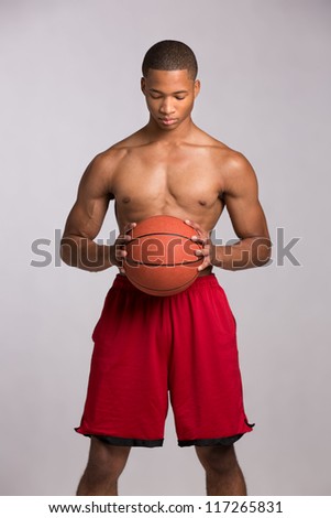 Young Black College Student Holding Basket Ball on Grey Background