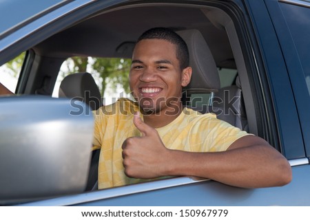Young Smiling African American Male Thumb up in a Car