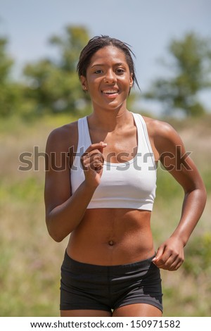 Healthy Natural Looking Young African American Female Runner under Summer Sunlight