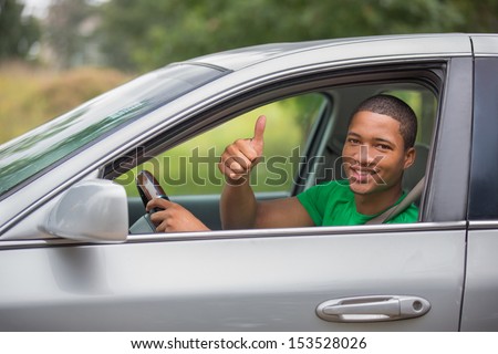 Young Smiling African American Male Thumb Up In A Car