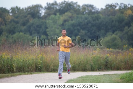 Young Healthy African American Jogging Outdoor Under Morning Sunlight