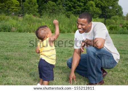 Happy African American Father and Son Playing Outdoor Park in Summer