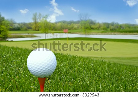 stock photo : golf ball on tee golf course background