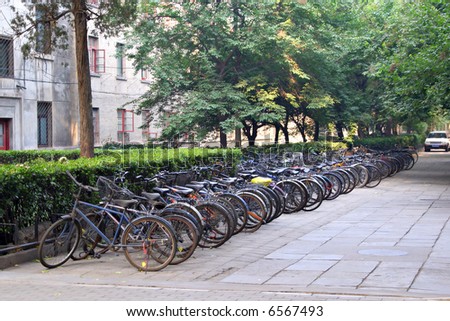 row of bikes parked behind apartment building, Beijing, China