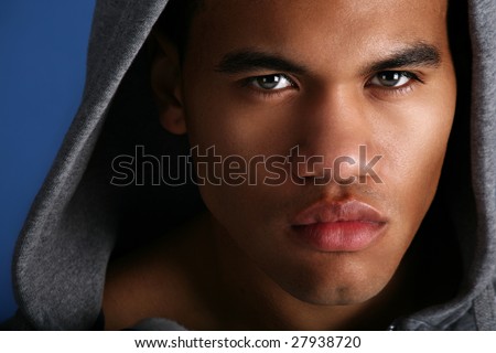 Young African American Male Low Key Portrait on Blue Background
