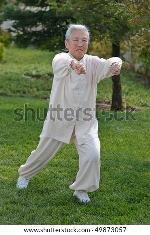 Chinese Elderly Woman Performing Taichi Outdoor