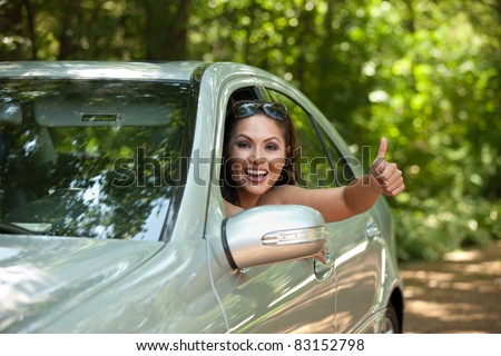 Joyful Asian Female Driver Arm Out of Car Window