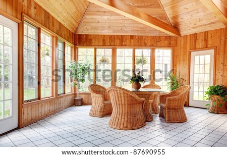 Wooden Wall Sun Room Interior with Natural Wicker Furniture, Ceramic  Tile floor