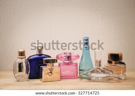 perfume bottle on wood desk on wall background