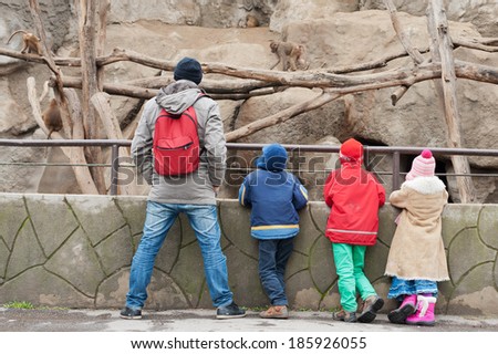 BUDAPEST, HUNGARY - February 22, 2014: Visitors of Budapest Zoo and Botanical Garden stand near the enclosure with monkeys