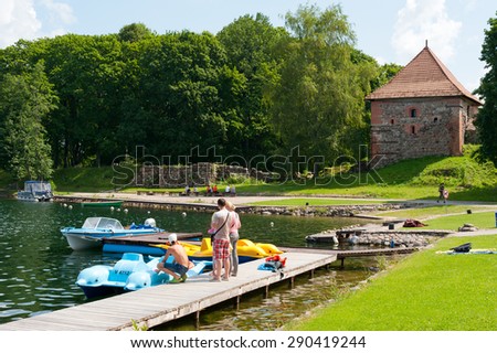 TRAKAI, LITHUANIA - JULY 19, 2014: Tourists rent a boat at Galve lake