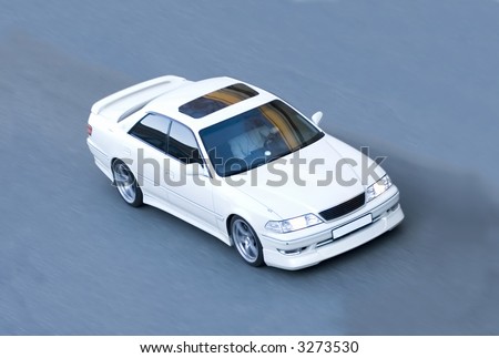 Beautiful white car (sportscar) on the road. Speed, power, spirit.