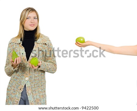one girl gives an apple to a another who already has an apple and a pear in her hands - See similar images of this \