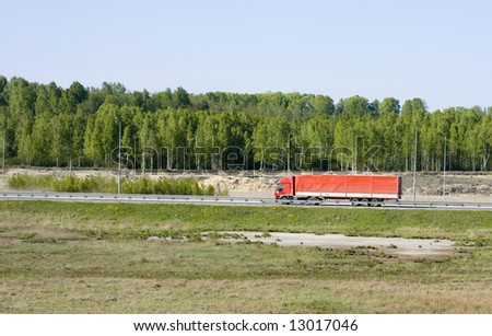big red truck shot from far away - rural landscape  - See similar images of this 