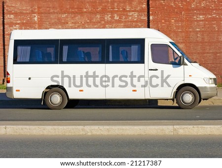 Small passenger Tour van bus on road