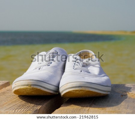 white golf shoes on a wood deck