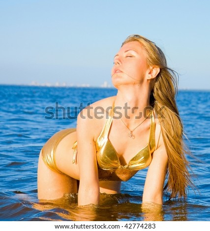 woman in golden bikini