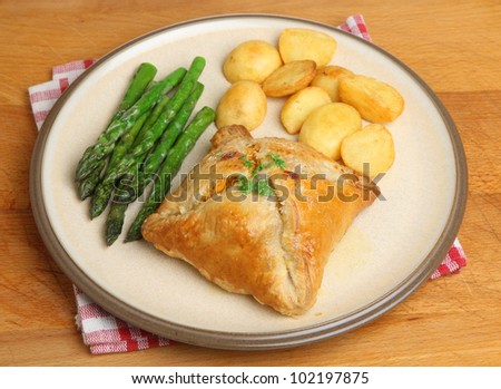 Chicken encroute pastry parcel with asparagus and potatoes