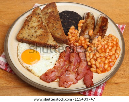 Full English cooked breakfast with bacon, sausages, egg, black pudding and baked beans.