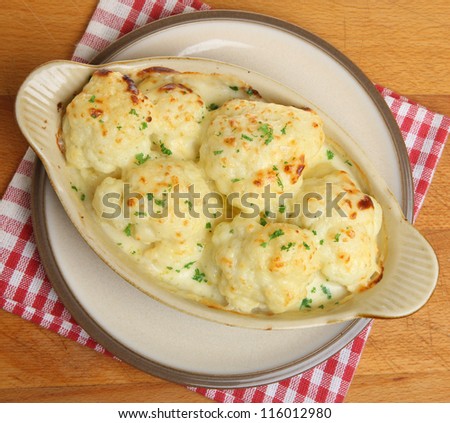 Cauliflower cheese or gratin in serving dish.