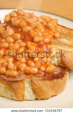 Baked beans on toast with visible steam rising.