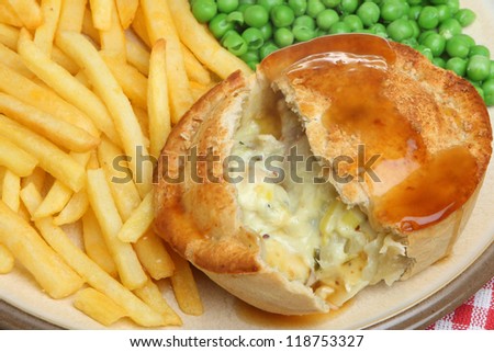 Chicken and vegetable pie with fries, peas and gravy.