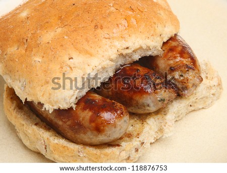 Char-grilled sausages in a wholemeal bread bap