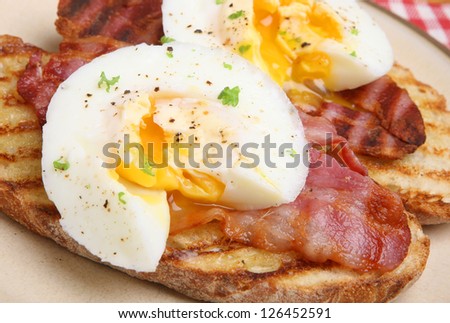 Poached eggs and bacon on toasted artisan bread.