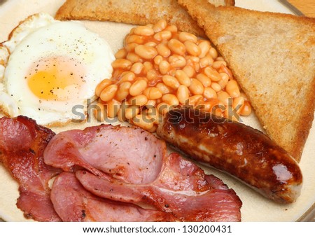 Full English breakfast with bacon, sausage, egg, baked beans and fried bread.