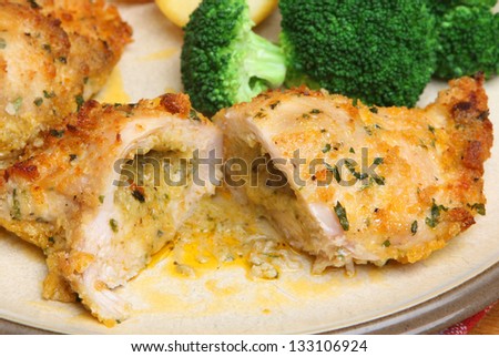 Chicken kiev dinner with broccoli and roast potatoes