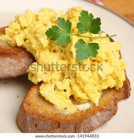 Scrambled eggs on toasted artisan bread.
