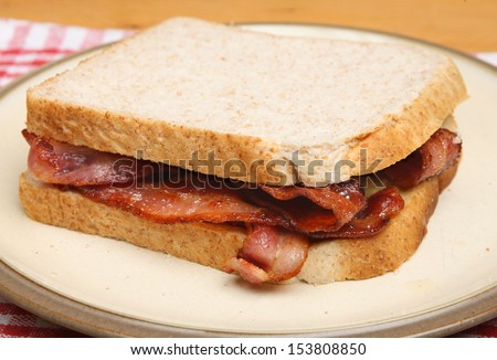 Bacon sandwich on plate.