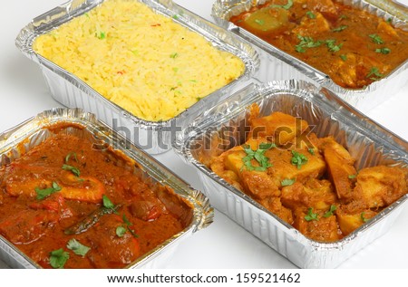 Indian takeaway food selection in foil containers.