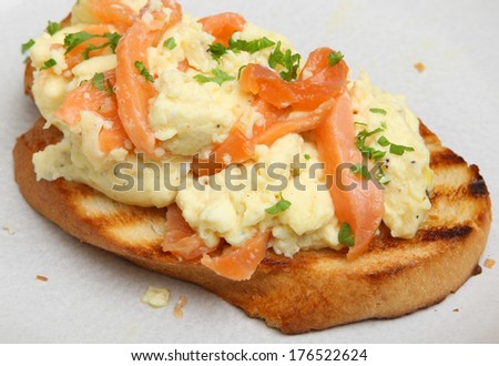 Scrambled eggs and smoked salmon on toasted artisan bread.