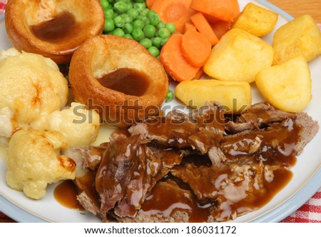 Roast lamb Sunday dinner with Yorkshire puddings.