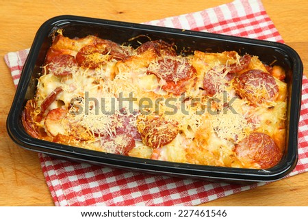 Pasta ready meal with salami sausage, ham and cheese.