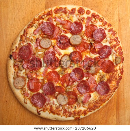Meat feast pizza with pepperoni, ham and spicy sausage topping.