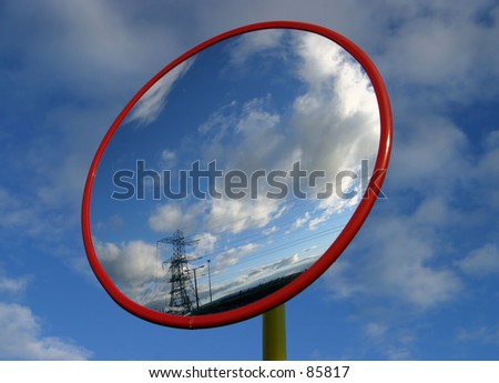 Mirror reflecting sky & electricity pylon