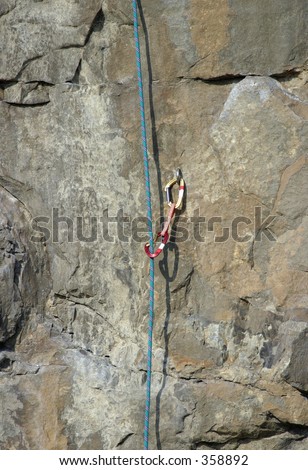 Detail of climbing equipment against sheer rock face