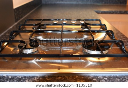Four burner gas hob in a modern fitted kitchen