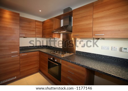 Interior of galley-style kitchen with integrated appliances __ selective focus on center