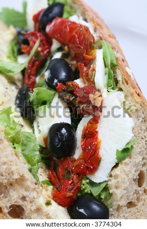 Baguette with mozzarella, sun-dried tomatoes and olives