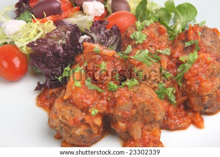 Greek lamb meatballs in tomato sauce with Greek side salad
