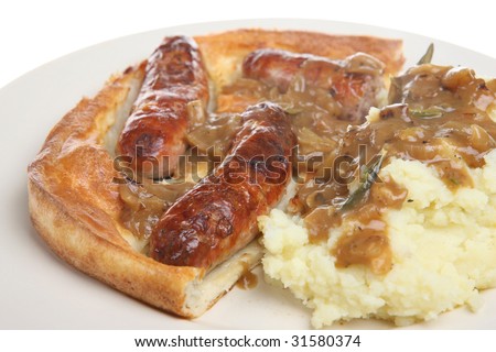 British dish of 'toad in the hole' with mash and onion gravy