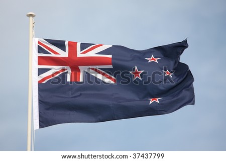 New Zealand flag flying in strong wind.