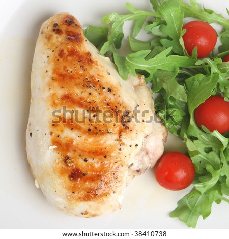 Grilled seasoned chicken breast with rocket salad