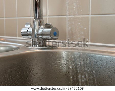 Kitchen sink mixer tap with cold water flowing