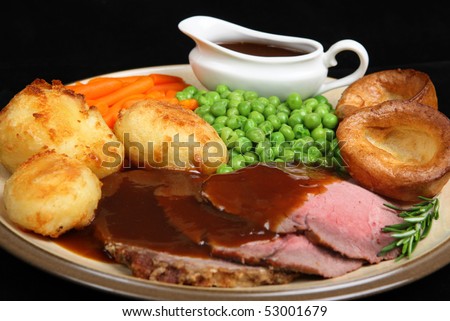British roast beef dinner with Yorkshire puddings.